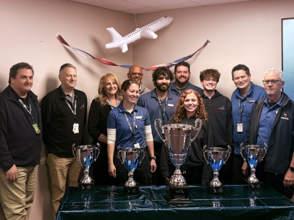 A group of people standing with awards
